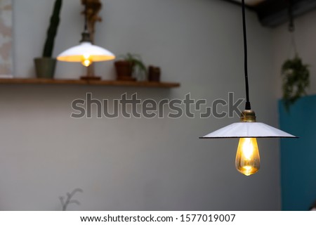 Lamps pending from the celling with vintage light bulbs in a trendy retro restaurant patio