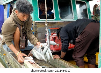 Lampung, Indonesia, October 07 2022: Two Indonesian Men Weigh Fish On A Fishing Boat In Lampung, Indonesia.