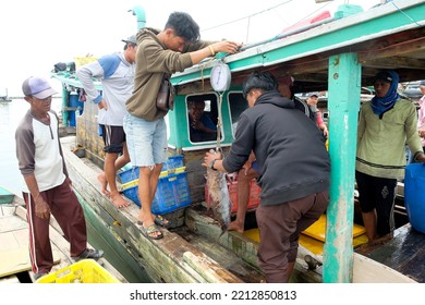 Lampung, Indonesia, October 07 2022: Two Indonesian Men Weigh Fish On A Fishing Boat In Lampung, Indonesia.