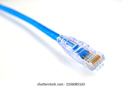 LAN CABLE OF INTERNET CLOSEUP PHOTO WITH WHITE BACKGROUND, INTERNET CABLE, ETHERNET AND NETWORK CABLE, SIMPLE LAN WIRE WITH BLUE COVER WITH RJ45 PIN-PLUG