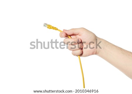 LAN ethernet cable in hand. Yellow RJ45 twisted pair cable for computer network. Cat 5e UTP connection. White isolated background