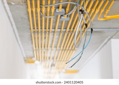 LAN network wire install in construction building with metal steel flexible conduit pipe with electricity wiring in PVC conduit pipe lines clean parallel installation.