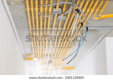 LAN network wire install in construction building with metal steel flexible conduit pipe with electricity wiring in PVC conduit pipe lines clean parallel installation.