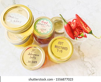 Lancaster, Ohio / USA - November 2019: Homemade Canned Jelly And Hot Mustard With Handwritten Labels With Year And Month. Expiration Dates On Jam Cans Glass Canning Jars. Handwritten Expiration Labels