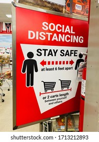 Lancaster Ohio/USA- April 2020: Social distancing sign at a store near the checkout lane telling customers to maintain a distance of two cart lengths due to COVID-19