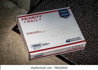 Lancaster, PA, USA - December 15, 2017: USPS Priority Mail Regional Rate Box  Package Delivered At A Residential Home Front Door.