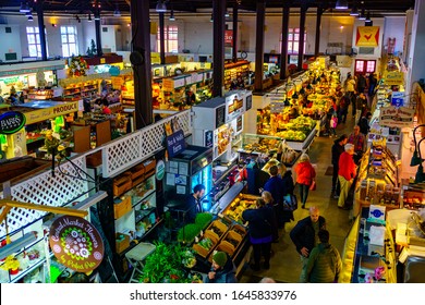 Lancaster, PA / USA - February 14, 2020: Standholder’s and shoppers actively engage in commerce at the city’s Central Market near Penn Square.