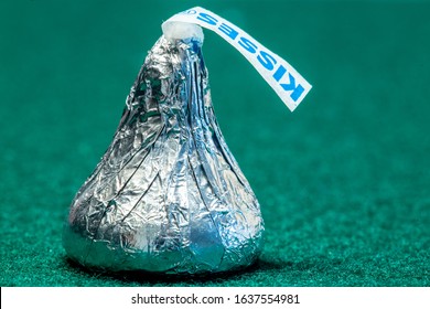 Lancaster, PA / USA - November 29, 2016: An illustrative editorial close-up image of a Hershey Chocolate Kiss on a green background.