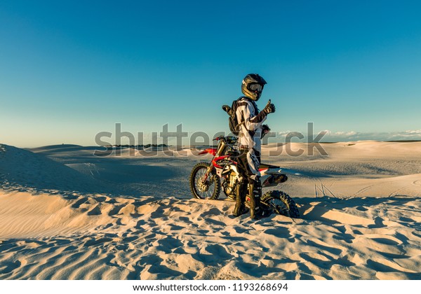 Lancelin,WA,Australia-September 28,2017:\
Motorbike rider riding on the flats of the Lancelin Sand Dunes in\
Western\
Australia.