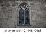 Lancet window on the exterior of the Romanesque Gothic style Église Sainte-Croix, a historic religious monument in Kaysersberg Alsace, France.