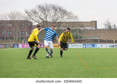 Lancing, England; 25th March 2018; Action Shots, Sunday League Amatur Football Match Between Hillside Rangers FC And AFC Beavers FC. Player Dribbles Between Two Opponents