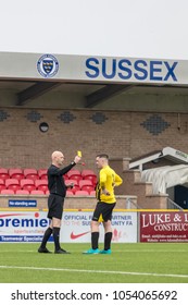 Lancing, England; 25th March 2018; Action Shots, Sunday League Amatur Football Match Between Hillside Rangers FC And AFC Beavers FC. Referee Shows Player Yellow Card