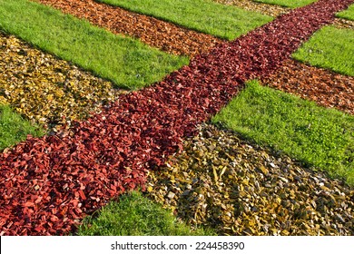 Land Art Of Colored Chips And Natural Grass.