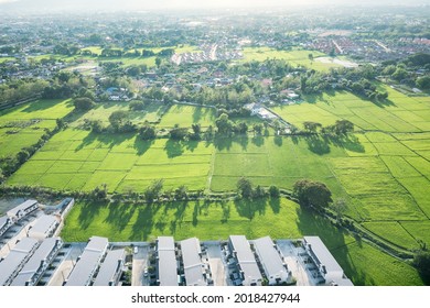 Land Or Landscape Of Green Field In Aerial View. Include Agriculture Farm, House Building, Village. That Real Estate Or Property. Plot Of Land For Housing Subdivision, Development, Sale Or Investment.