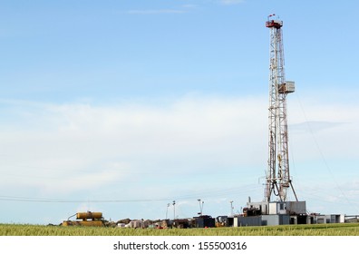land oil drilling rig in green wheat field