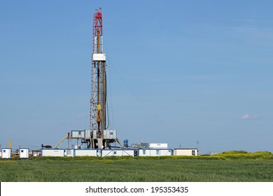 land oil drilling rig on green field landscape