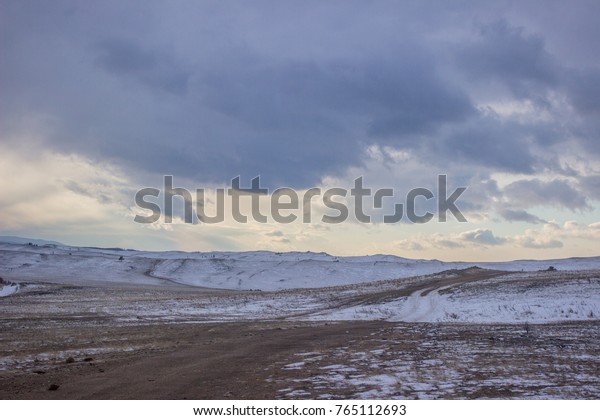Land on Lake Baikal in winter, where snow begins\
to thicken on the route.