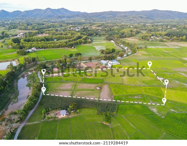Land plot in aerial view, Top view land green\
field agriculture plant with pins, pin location icon for housing\
subdivision residential development owned sale rent buy or\
investment countryside\
suburbs
