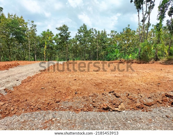 Land plot for housing construction\
project with car tire print in rural area and beautiful blue sky\
with fresh air . Land for sales landscape\
concept.