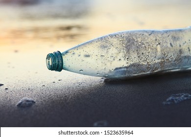 land and sea pollution pollution, ecological problem, used plastic bottle on sea shore, sunset light - Shutterstock ID 1523635964