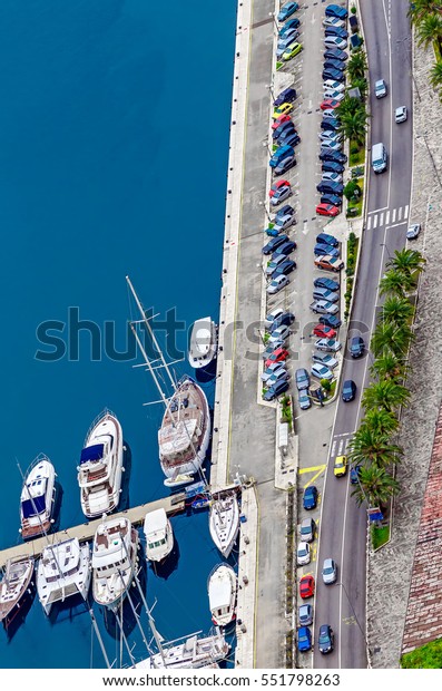 Land and sea transportation. Top view on cars on\
the road and boats in\
marine.