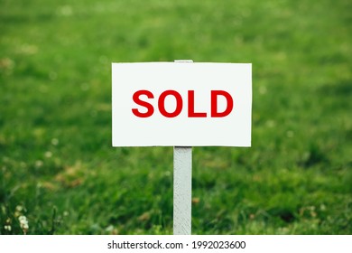 Land Sold Plate Sign, Green Grass Background