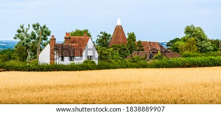 Landcape of a traditional wooden English country house on the fields in Kent, England, Uk