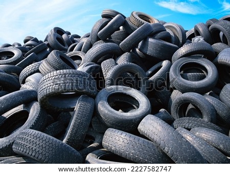 Landfill with old tires and tyres for recycling, Reuse of the waste rubber tyres, Disposal of waste tires, Worn out wheels for recycling, Tyre dump burning plant, Regenerated tire rubber.
