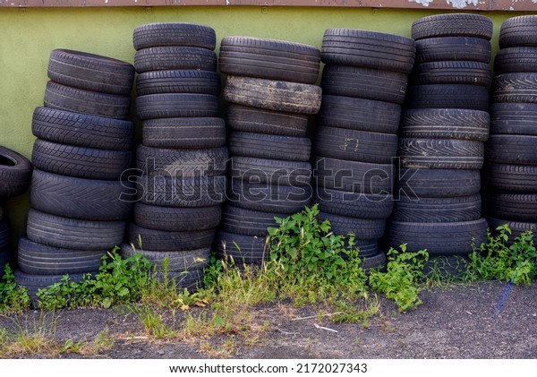 Landfill\
with old tires and tyres for recycling. Disposal of waste tires.\
Worn out wheels for recycling. Tyre dump burning plant. Regenerated\
tire rubber produced. stacks of old used tires.\
