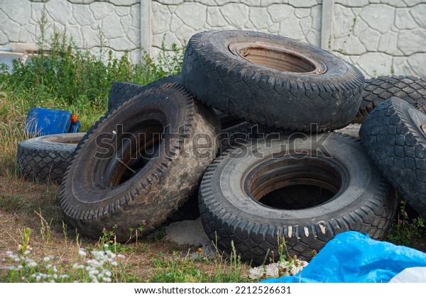 Landfill with old tires and tyres for\
recycling. Reuse of the waste rubber tyres. Disposal of waste\
tires. Worn out wheels for recycling. Tyre dump burning plant.\
Regenerated tire rubber\
produced.