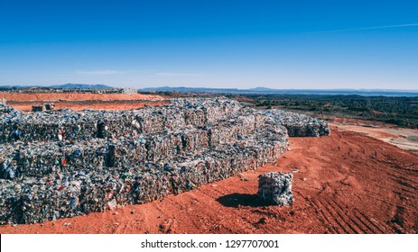 A Landfill Site Full Of Trash Plastic In The Desert Orange Soil Territory, Aerial View