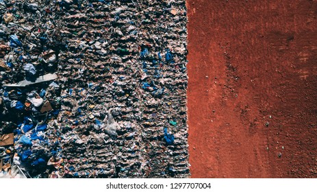 A Landfill Site Full Of Trash Plastic In The Desert Orange Soil Territory, Aerial View