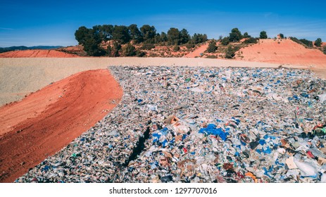 A Landfill Site Full Of Trash Plastic In The Desert Orange Soil Territory, Aerial View