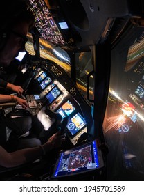 Landing From The Airplane Cabin At Night. The Pilot Lands His Aircraft Watching The Lights Of The Runway And The Airport