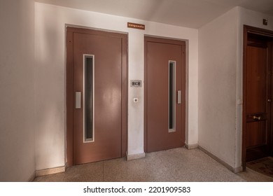 Landing Of An Apartment Building With Brown Painted Metal Elevator Doors