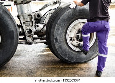 Landing Gear,wheel And Tire Of Commercial Airplane During Inspection And Maintenance At Aircraft Hangar By Aircraft Mechanic .Tire Pressure Check And Maintenance Service Check By Aircraft Technician .