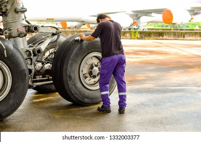 Landing Gear,wheel And Tire Of Commercial Airplane During Inspection And Maintenance At Aircraft Hangar By Aircraft Mechanic .Tire Pressure Check And Maintenance Service Check By Aircraft Technician .