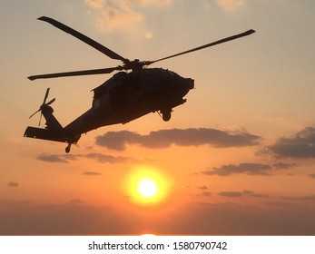 Landing inbound while sun is setting in backdrop.