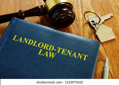 Landlord Tenant Law Book And Key From Home.