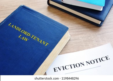 Landlord-Tenant Law and eviction notice on a desk. - Shutterstock ID 1198448296
