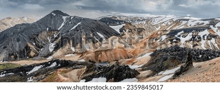 Landmannalaugar, Iceland. Panoramic view from above at beautiful Icelandic landscape of colorful rainbow volcanic Landmannalaugar mountains, at Laugavegur hiking trail with lava field and dramatic sky