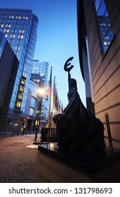 The Landmark Statue Holding The Euro Symbol In Front Of The European Parliament Building In Brusels (Bruxelles), Belgium.