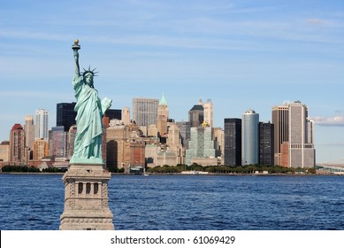 The landmark Statue of Liberty against the impressive New York City skyline. - Shutterstock ID 61069429