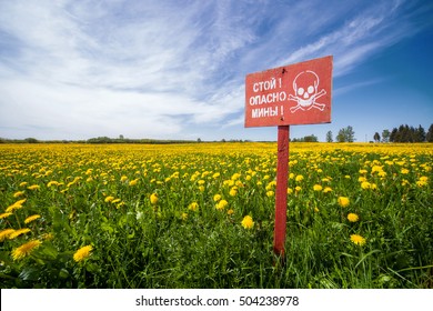 Landmines sign, danger minefield in the Falklands.Flowers and mines