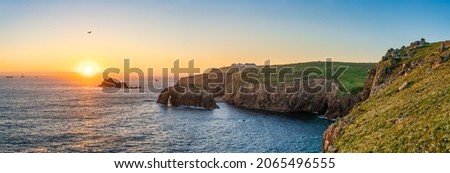 Land's End with Enys Dodman arch at sunset, Cornwall