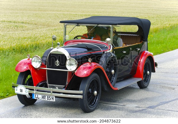 LANDSBERG, GERMANY - JULY 12, 2014: Public oldtimer\
rally organized by Bavarian city Landsberg for at least 80 years\
old veteran cars with unknown drivers in Hotchkiss open Tourer,\
built at year 1928