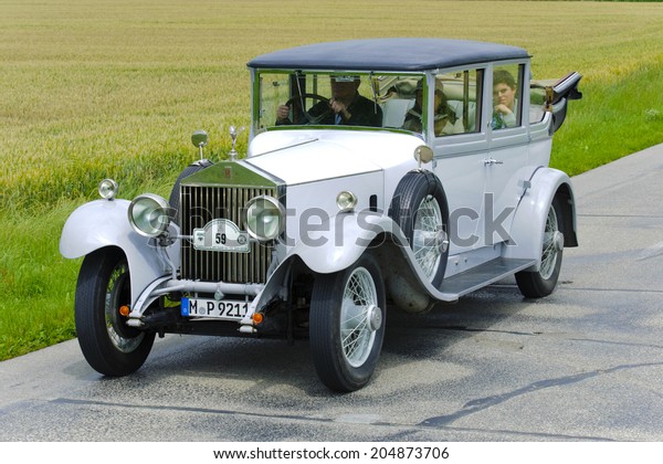 LANDSBERG, GERMANY - JULY 12, 2014: Public oldtimer\
rally organized by Bavarian city Landsberg for at least 80 years\
old veteran cars with unknown drivers in Rolls Royce Phantom I,\
built at year 1928
