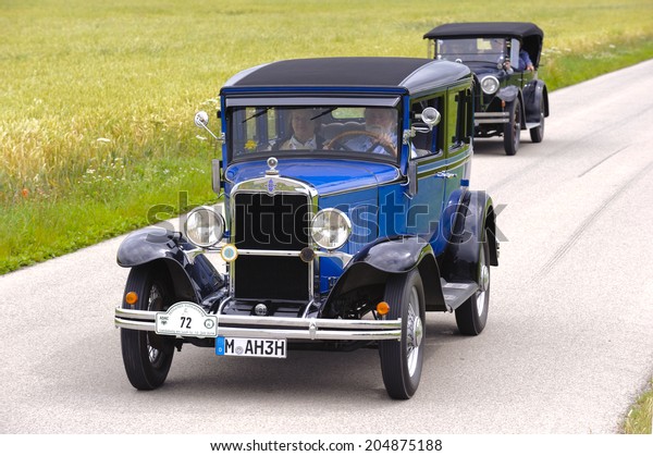 LANDSBERG, GERMANY - JULY 12, 2014: Public oldtimer\
rally organized by Bavarian city Landsberg for at least 80 years\
old veteran cars with unknown drivers in Chevrolet AD Sedan, built\
at year 1930