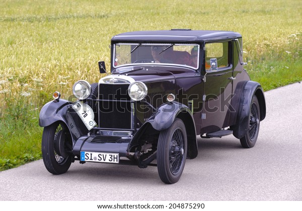 LANDSBERG, GERMANY - JULY 12, 2014: Public oldtimer\
rally organized by Bavarian city Landsberg for at least 80 years\
old veteran cars with unknown drivers in Sunbeam 16 HP, built at\
year 1930