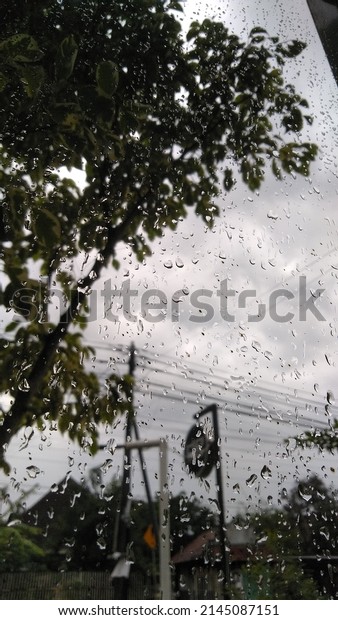 landscape\
after rain with water splash on outdoor\
glass